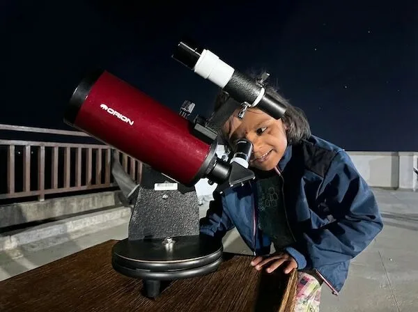 Student stargazing through telescope - experiential learning at Vidyan Earth School